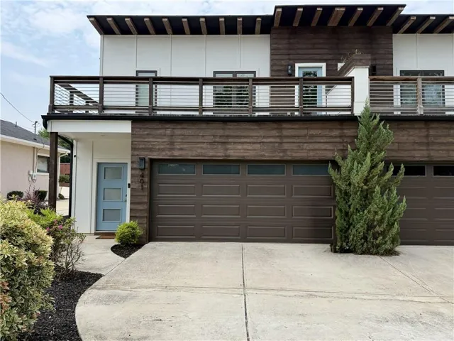 Modern facade featuring white siding and horizontal wood paneling