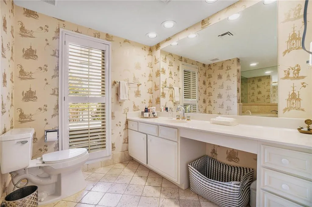Bathroom featuring vanity, walk in shower, recessed lighting, wallpapered walls, and light tile patterned floors Bathroom featuring vanity, walk in shower, recessed lighting, wallpapered walls, and light tile patterned floors