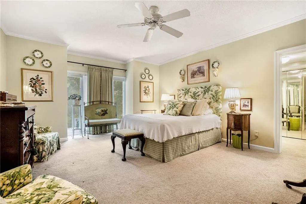 Carpeted bedroom featuring access to exterior, crown molding, a ceiling fan, and a textured ceiling Carpeted bedroom featuring access to exterior, crown molding, a ceiling fan, and a textured ceiling