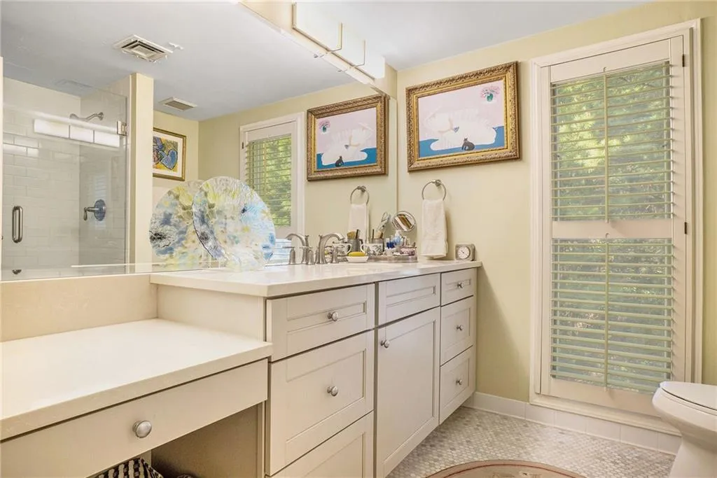 Full bath with vanity, a shower stall, and light tile patterned floors Full bath with vanity, a shower stall, and light tile patterned floors