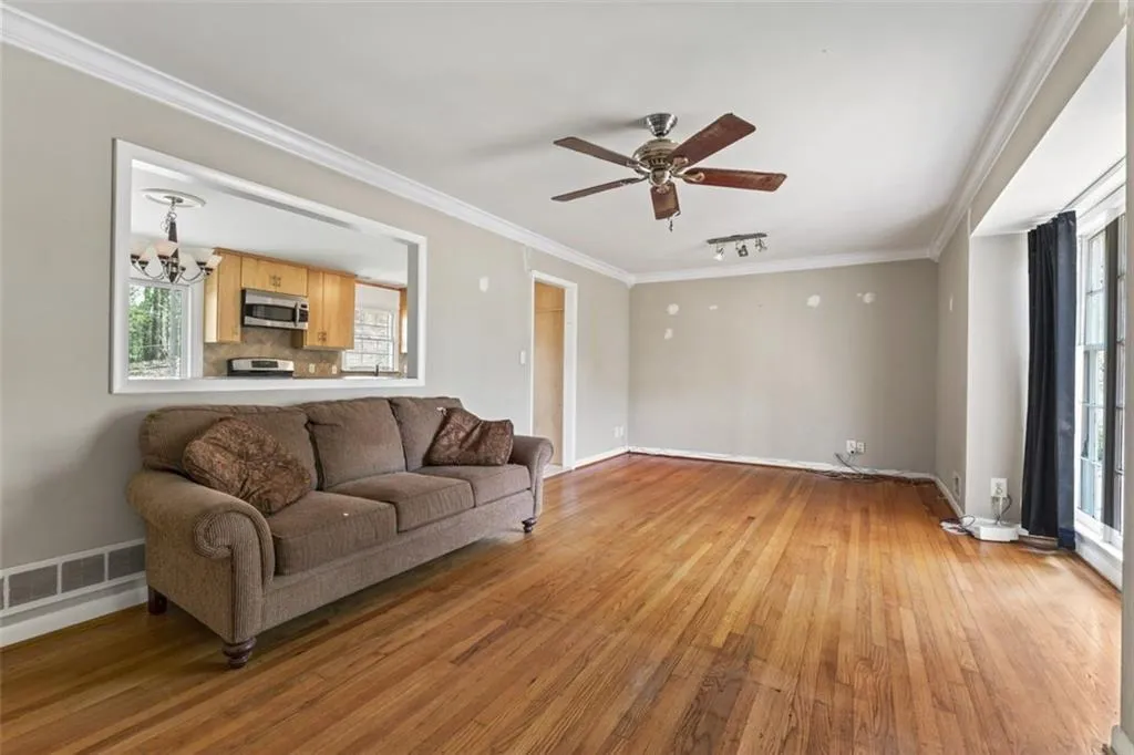 Living room featuring view window into the kitchen.
