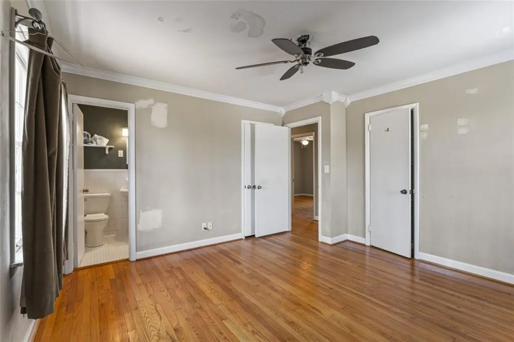 Master bedroom featuring hardwood floors and a ceiling fan.