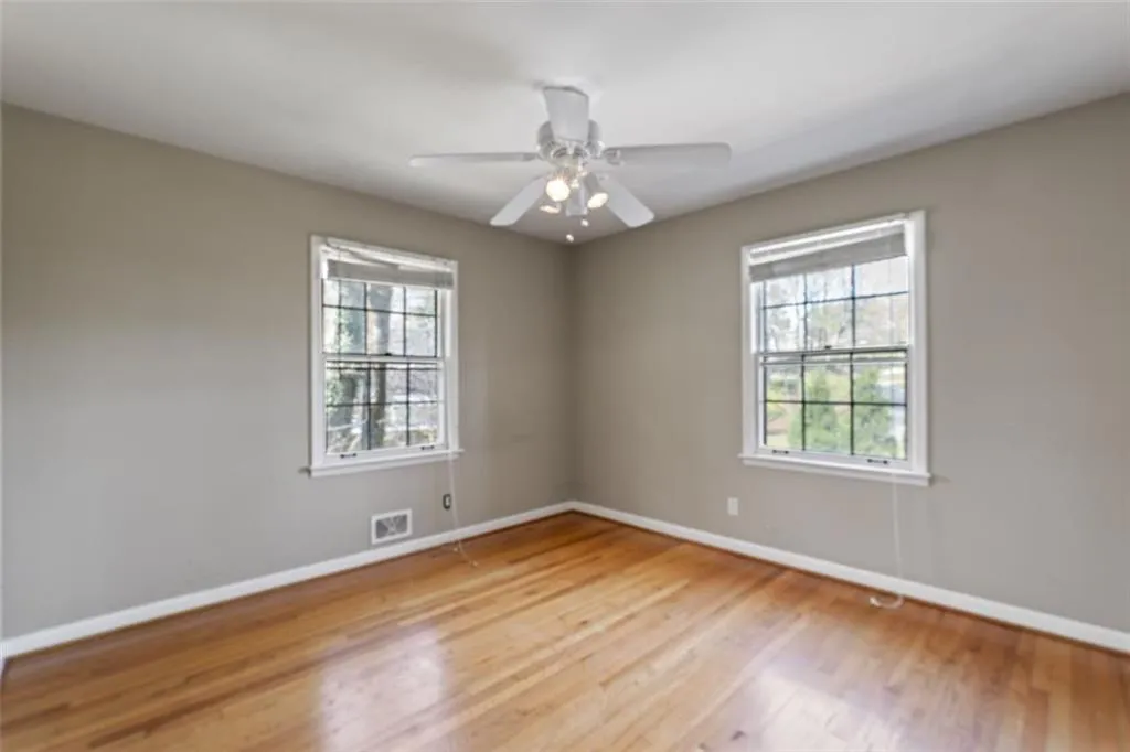 Bedroom with light hardwood floors and ceiling fan