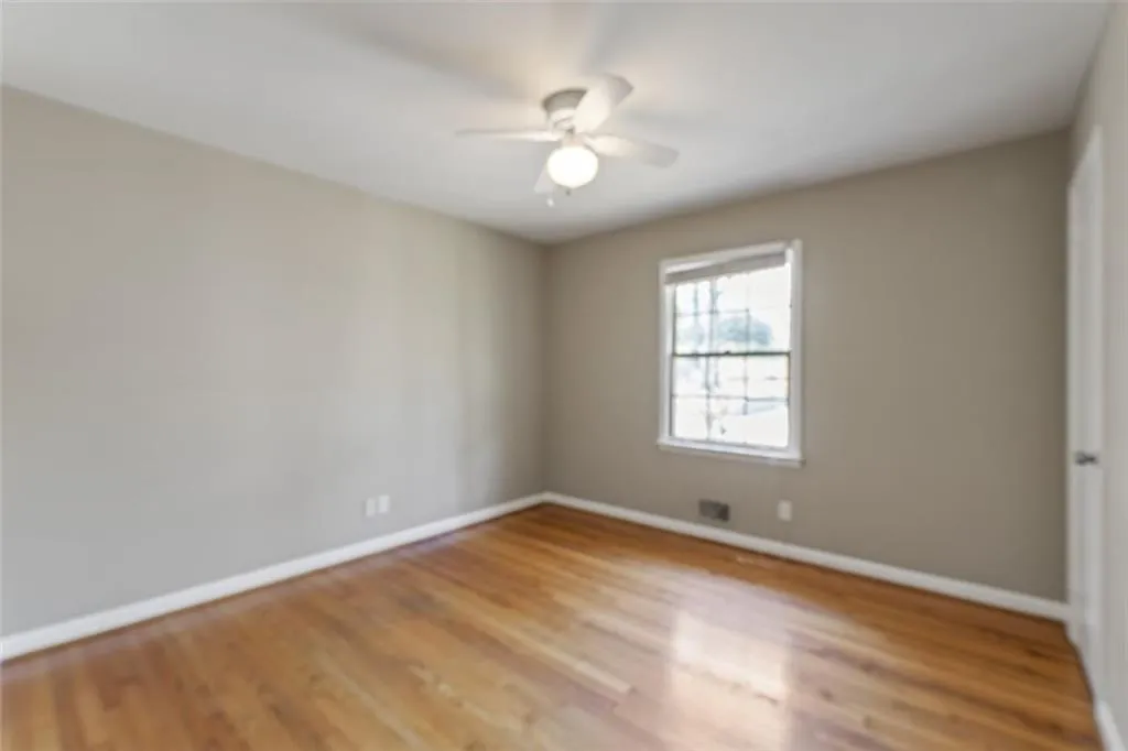 Bedroom with light hardwood floors and ceiling fan