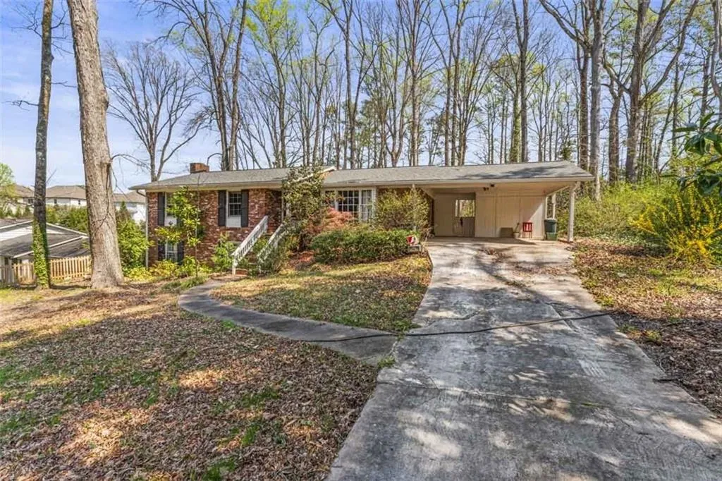 Ranch-style home featuring a carport