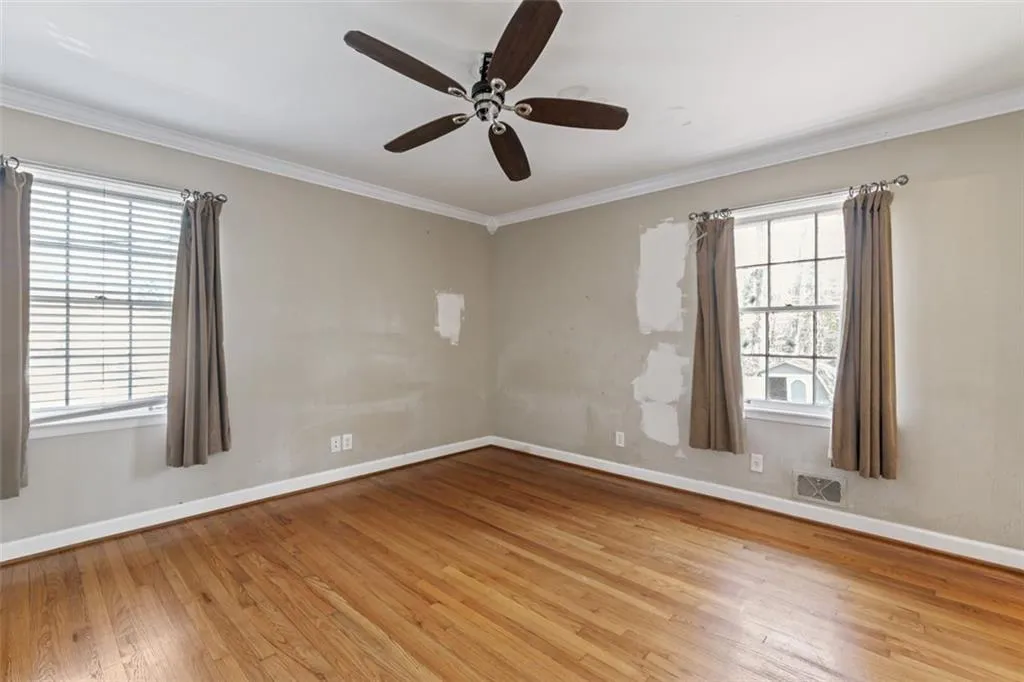 Master bedroom featuring hardwood floors and a ceiling fan.