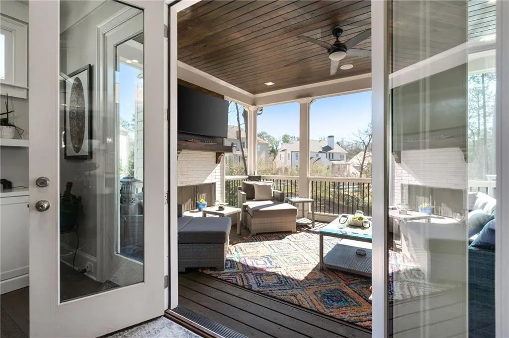 Screened sunroom with fireplace off great room