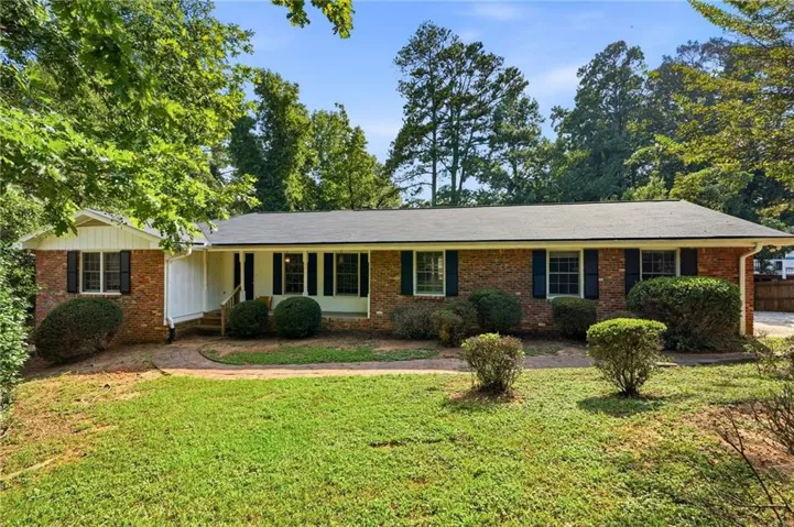 Brick exterior with a dark roof and white trim