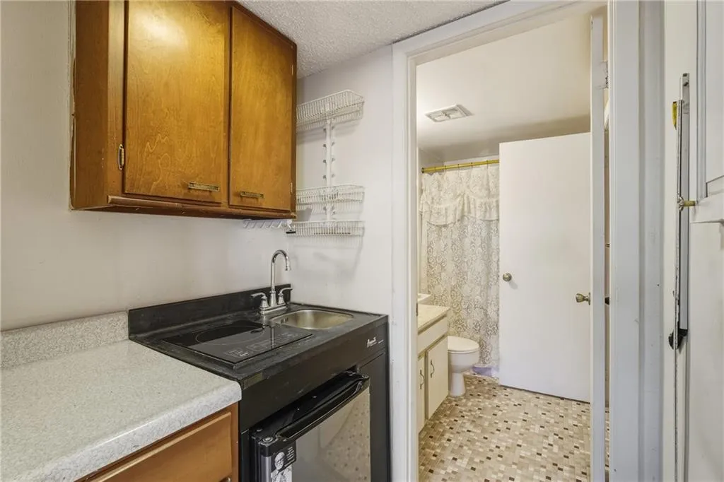 Bathroom featuring vanity, a shower with curtain, and a textured ceiling