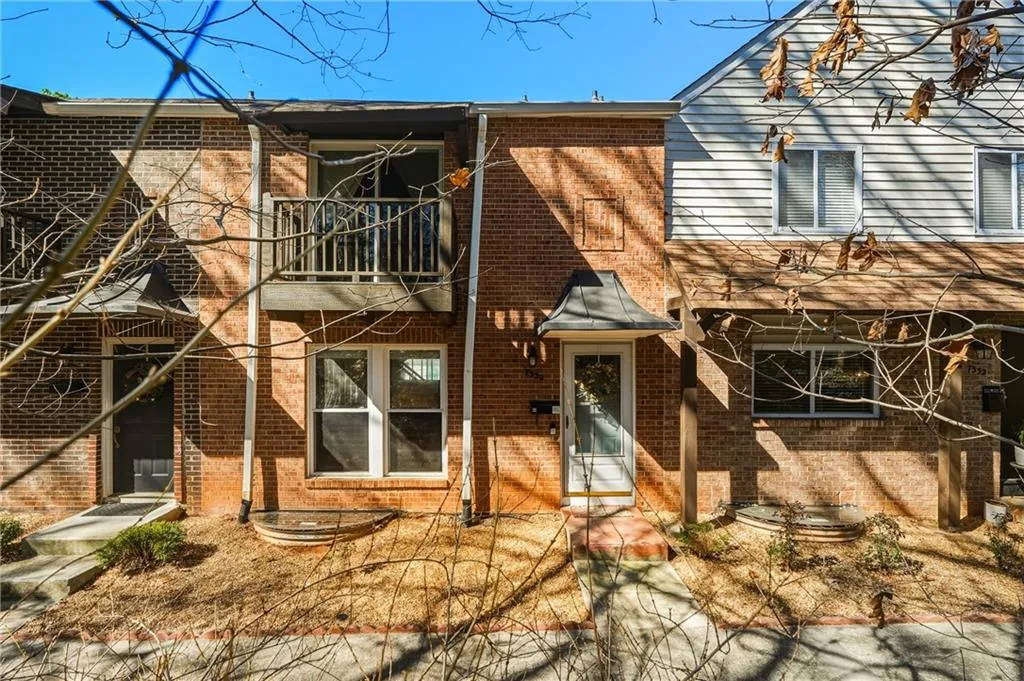Rear view of property with brick siding