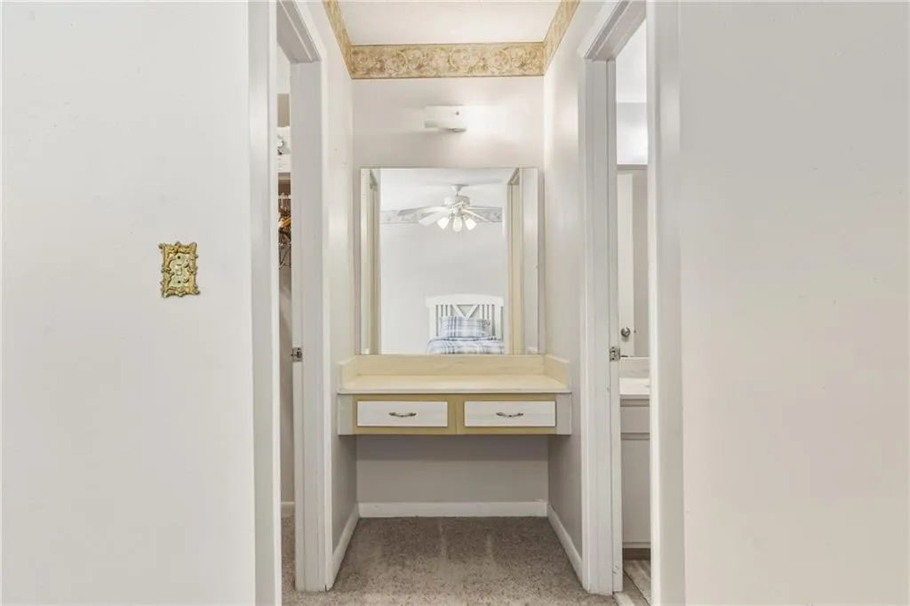 Walk in closet featuring light colored carpet