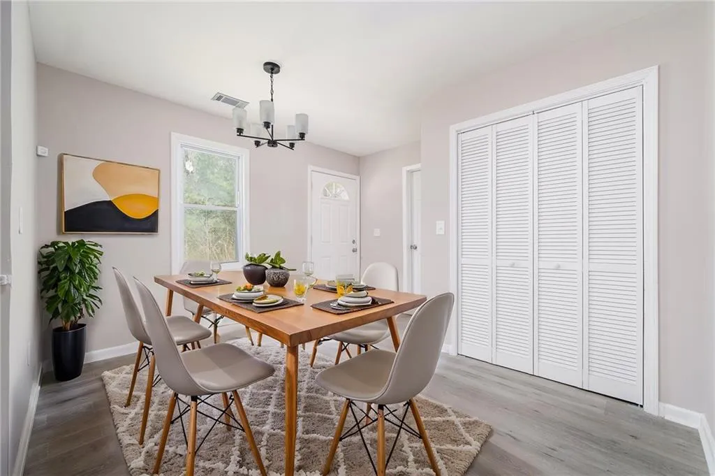 Dining area with wood finished floors and a chandelier