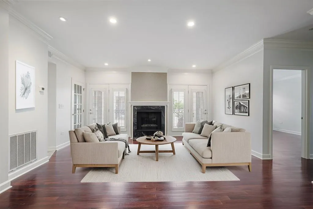 Virtually Staged Fireside living room opens to balcony, kitchen and dining areas...