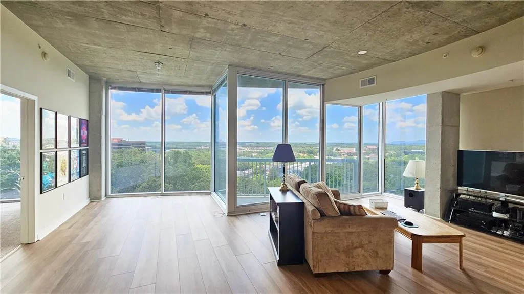 Living area featuring wood finished floors and floor to ceiling windows