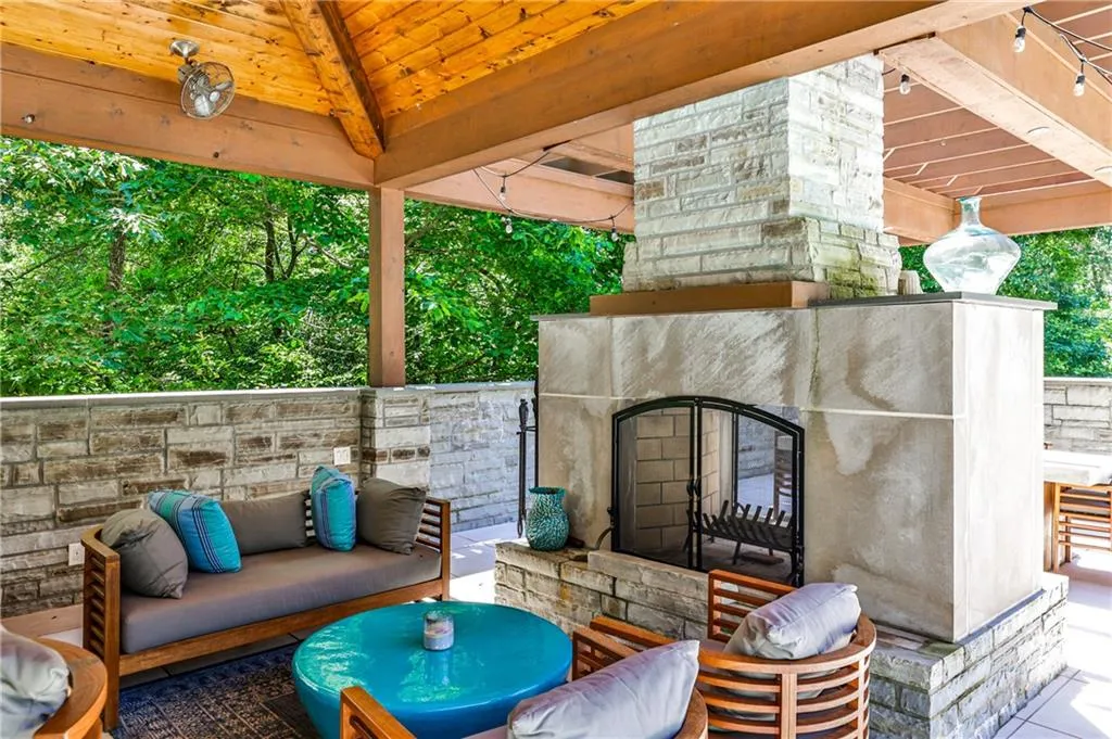 Double sided fireplace in outdoor kitchen area.