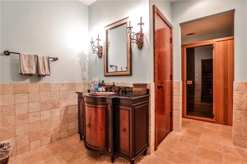 Lower level bath with sauna off gym.