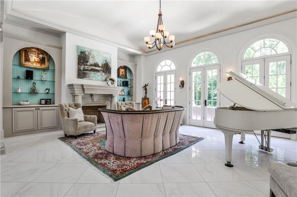 Three sets of French doors lead from the living room to the back patio and pool area.