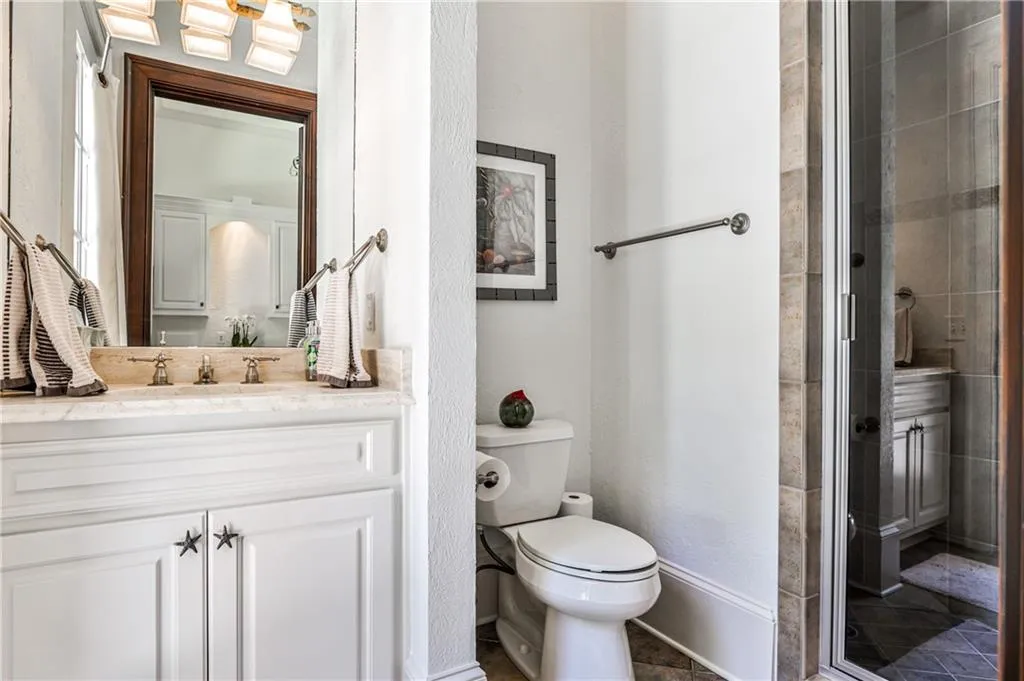 Bath with shower enters off the back patio from the pool.