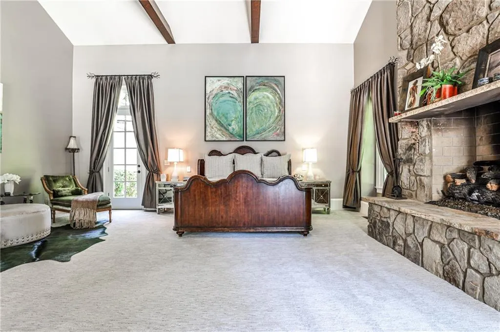 Primary bedroom with beamed Cathedral ceiling.