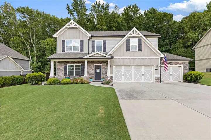 Two-story exterior with stone veneer and siding accents