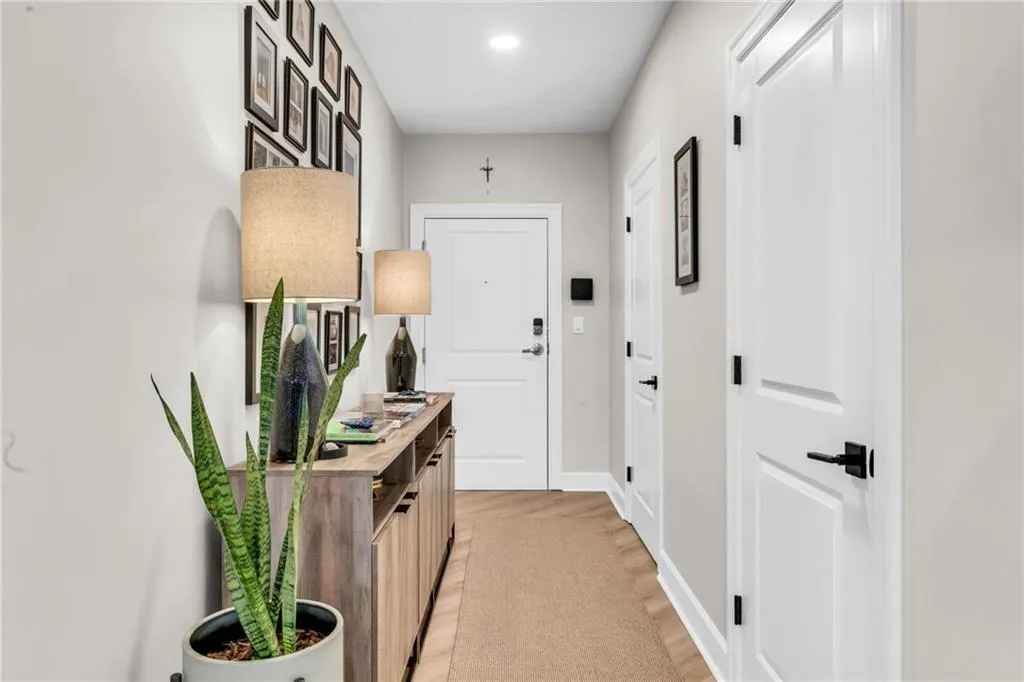 The doors lead to a laundry closet + a storage closet with shelving.