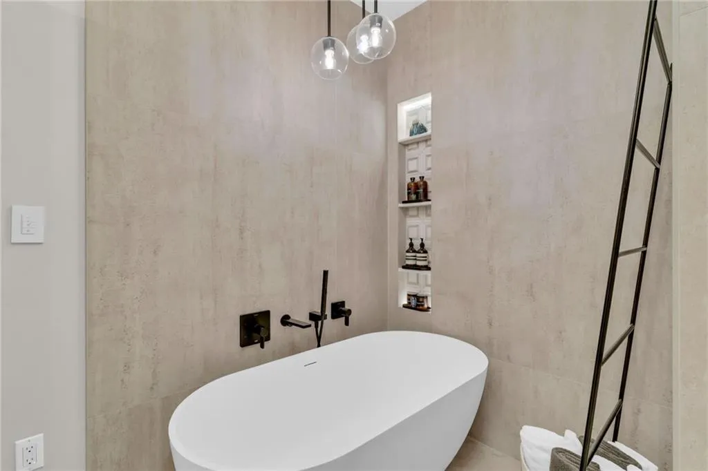 Resin sculptural tub. Lighting can be adjusted to create a spa vibe.