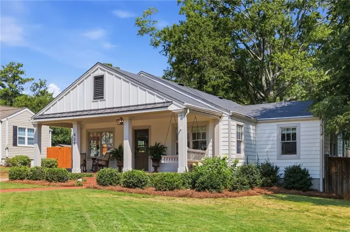 Front exterior featuring a covered porch, board and batten siding, horizontal siding, and a metal roof accent