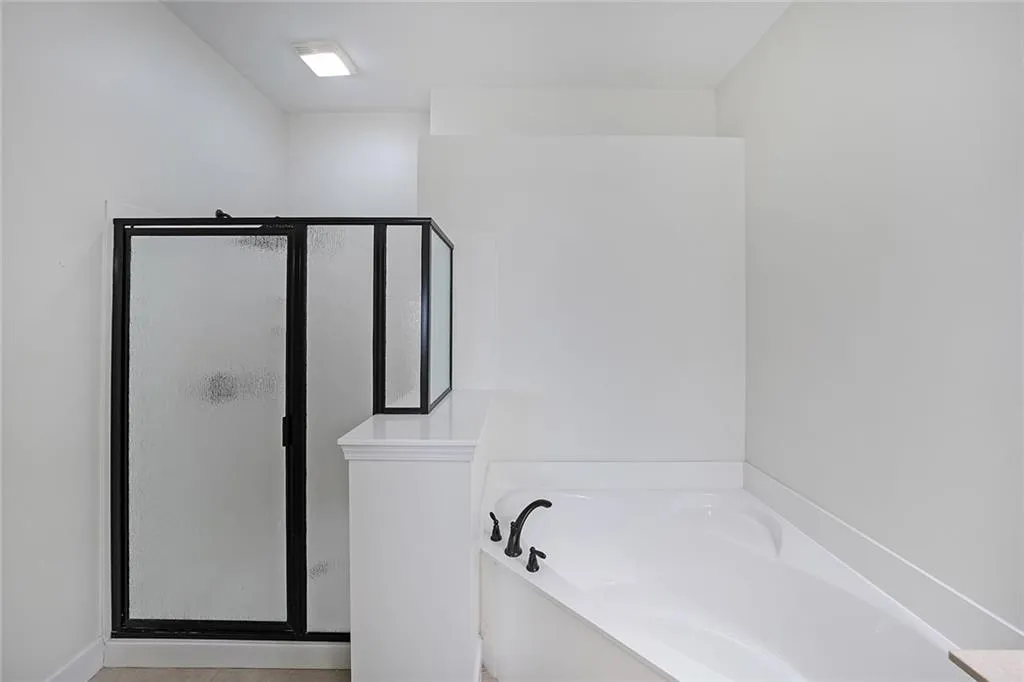 Full bathroom with a stall shower and a bath