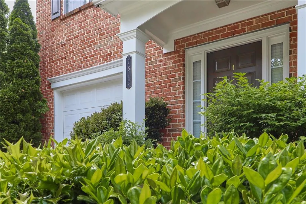 View of exterior entry with brick siding