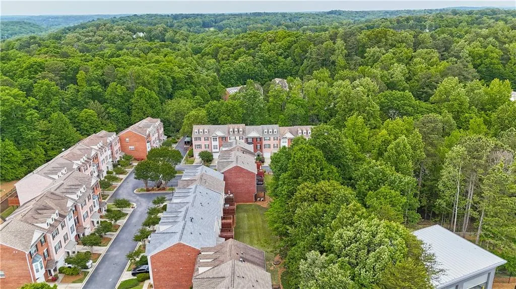 Aerial view featuring a wooded view