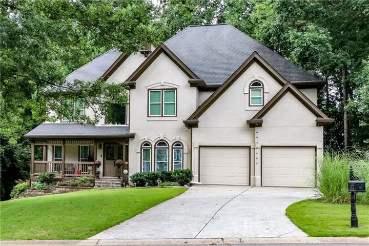 Beautiful exterior with a dark shingle roof and brown trim accents