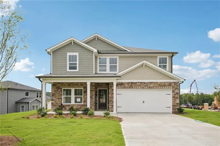 Two-story residence featuring a stone and siding facade, covered front porch, an attached two-car garage, and a concrete driveway