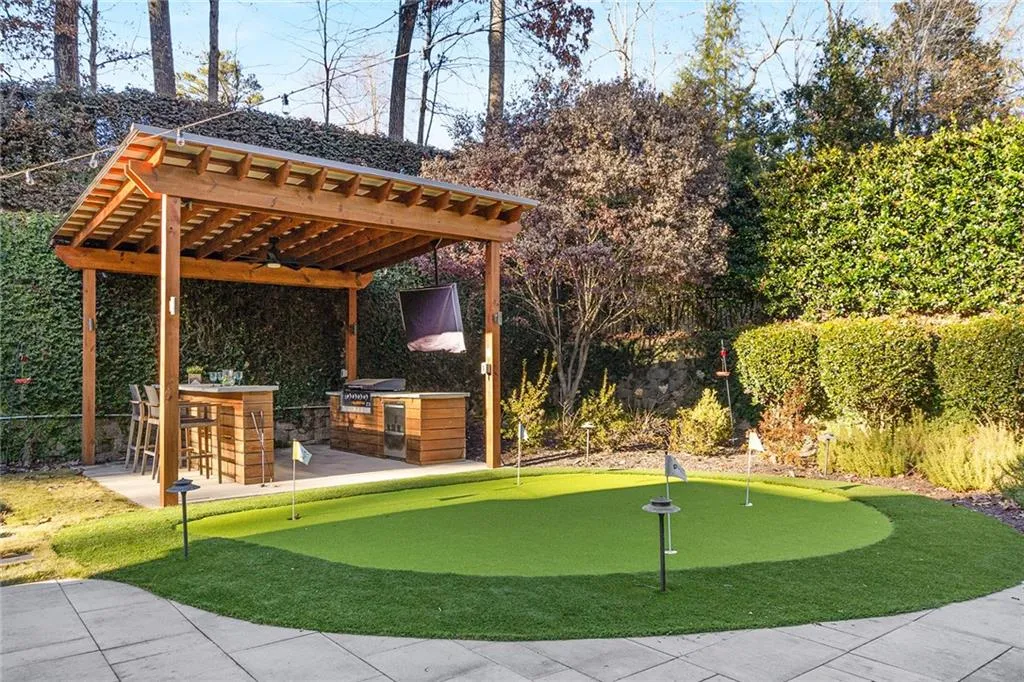 Welcome to your outdoor oasis!  This low maintenance yard is stacked with entertainment features including this bar and putting green!