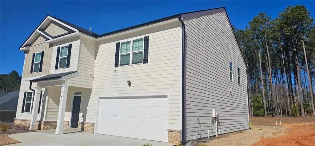 Craftsman house featuring an attached garage, concrete driveway, a porch, and brick siding