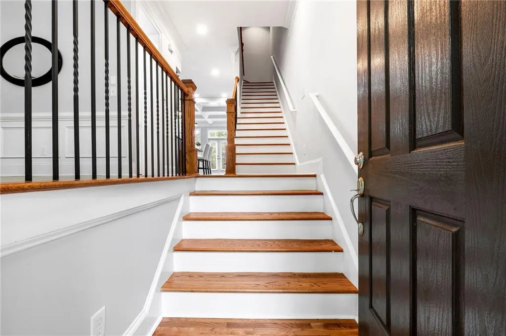 Staircase featuring wood finished floors and recessed lighting