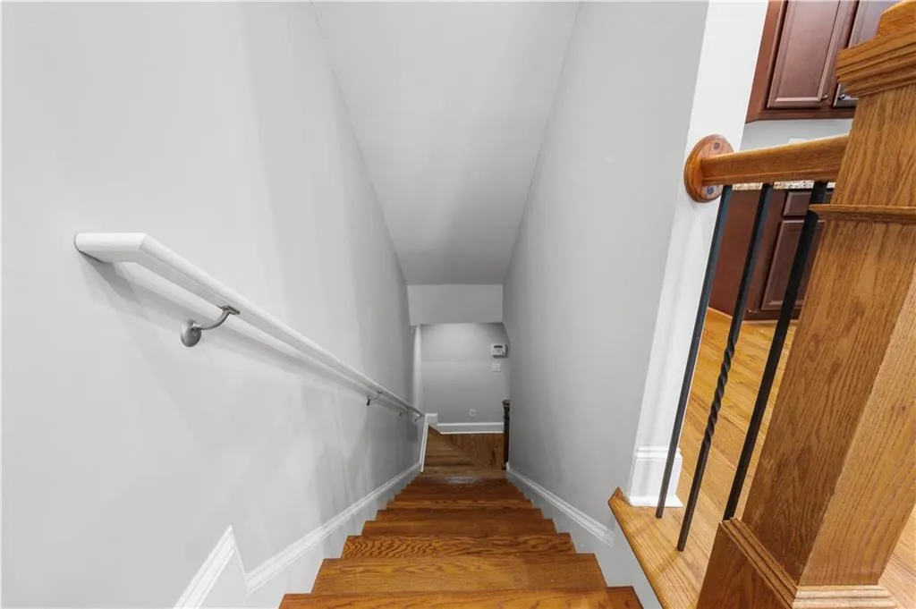 Stairway with baseboards and wood finished floors