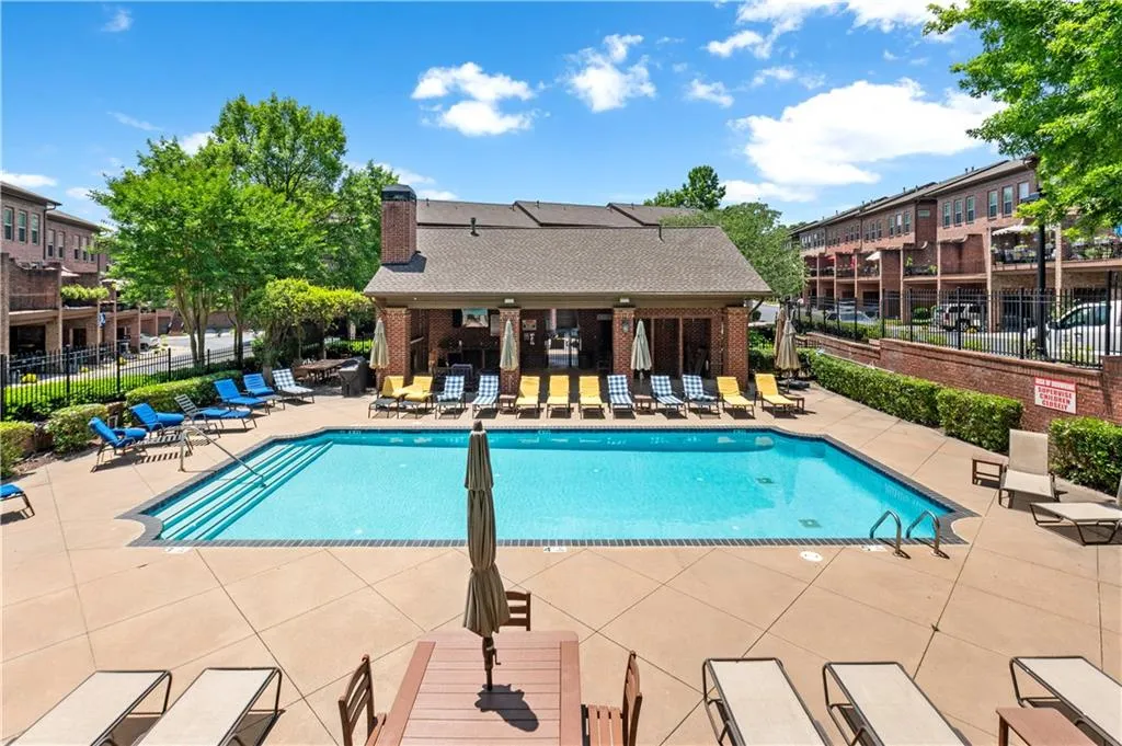 Community pool featuring fence and a patio area