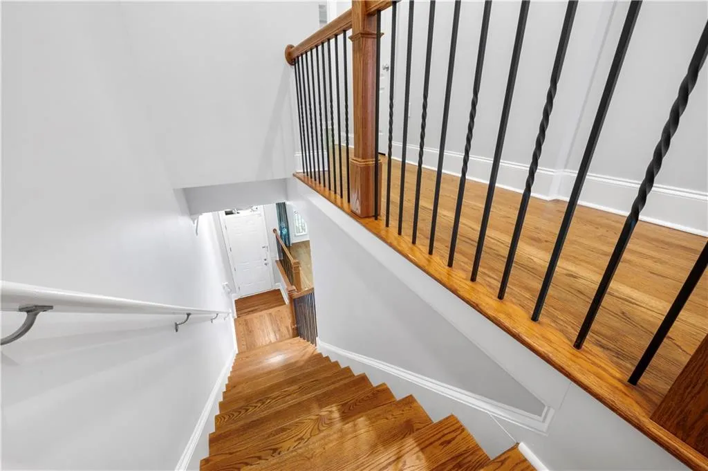 Staircase featuring wood finished floors and baseboards
