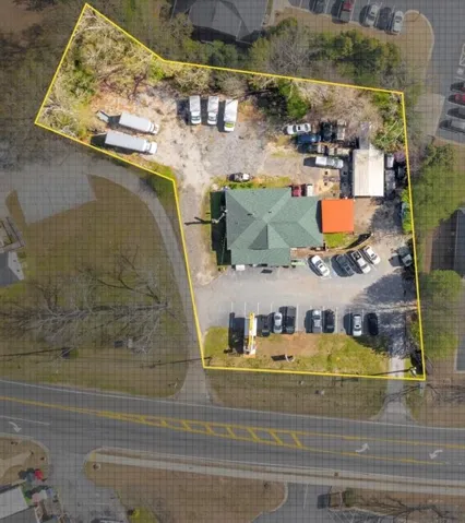 Aerial view of property and surrounding area featuring property boundaries highlighted