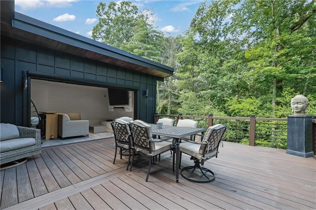 Deck featuring outdoor dining space and view of scattered trees