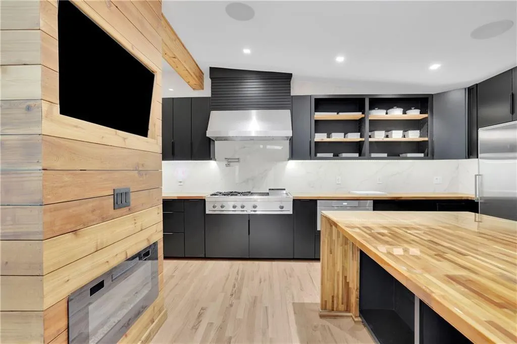 Kitchen featuring dark cabinets, backsplash, modern cabinets, open shelves, and recessed lighting