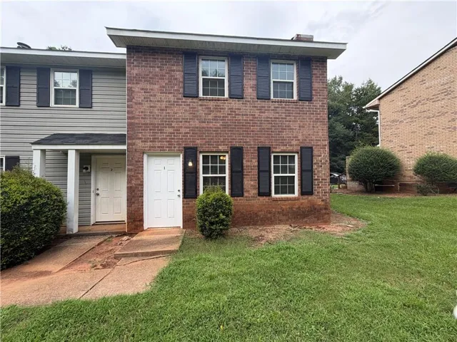 Brick exterior with black shutters and white trim