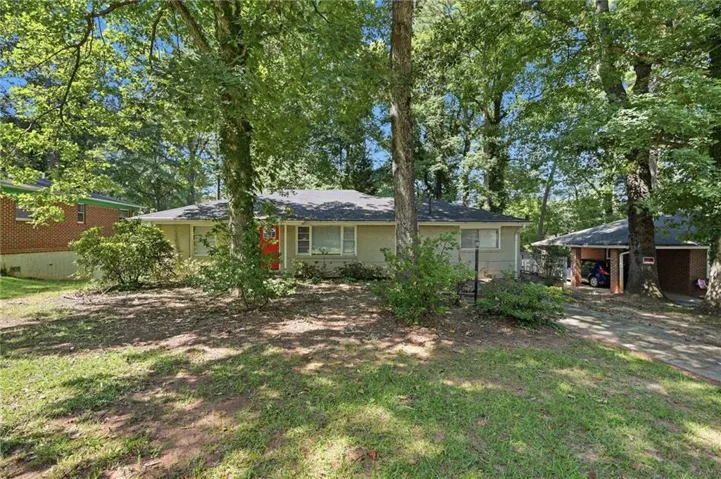 Ranch-style exterior with a contrasting red front door