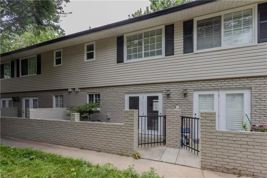 Back of house with brick siding and french doors