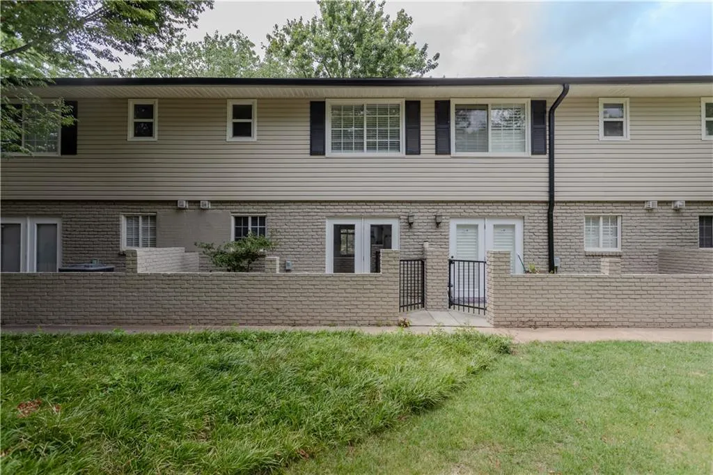 Rear view of house featuring brick siding