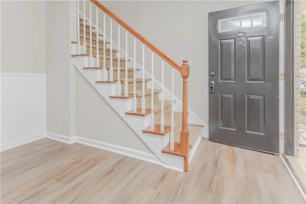 Foyer featuring wood finished floors and stairway