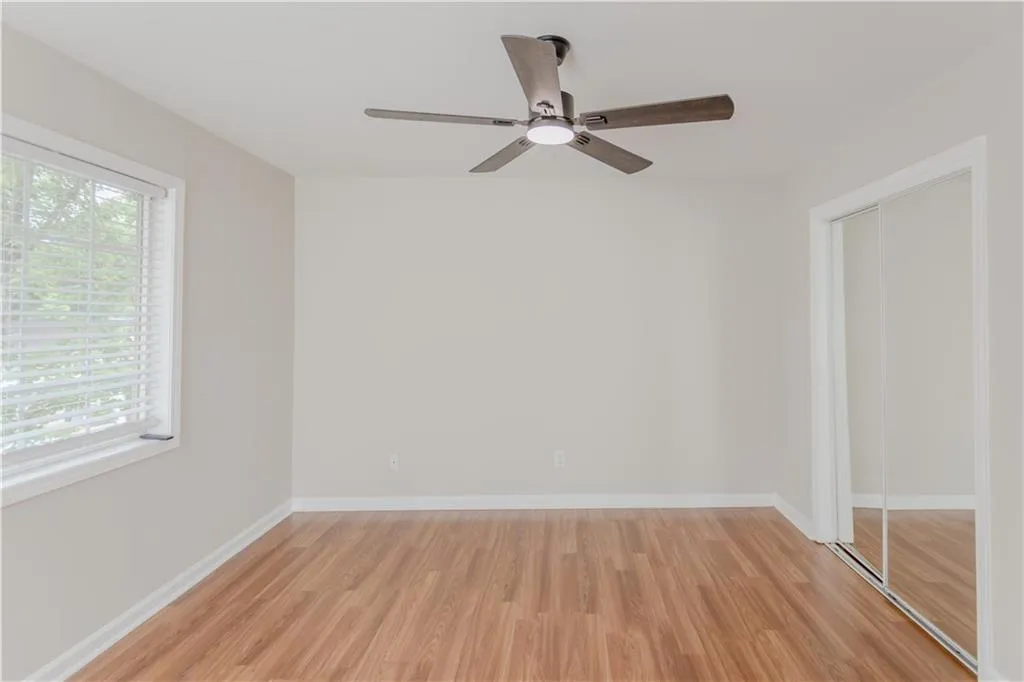 Unfurnished bedroom featuring light wood-style floors and ceiling fan