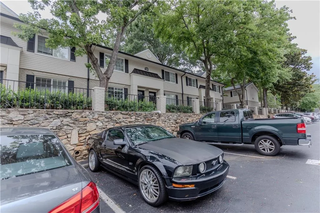 View of front of house featuring uncovered parking and brick siding