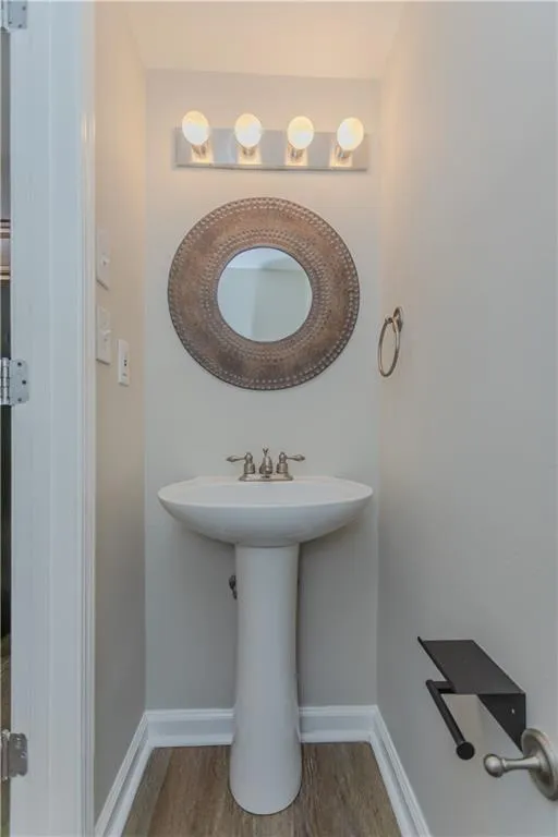 Bathroom with baseboards and wood finished floors