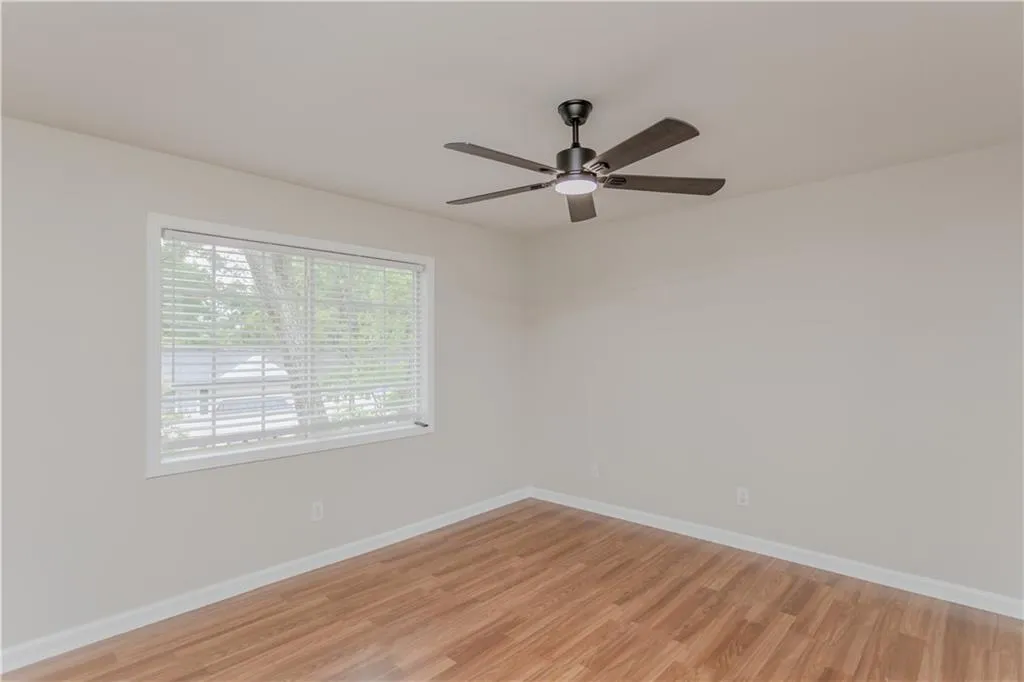 Spare room featuring light wood-type flooring and ceiling fan